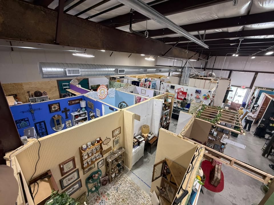 Rows of individually decorated vendor booths inside The Booth Scene indoor market in Hensley, Arkansas