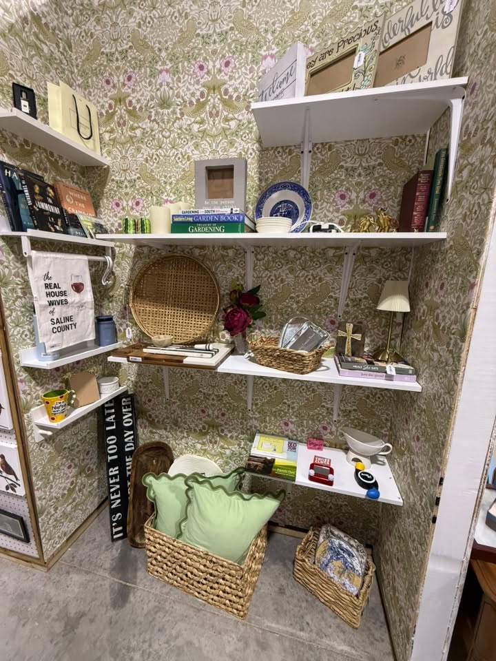 Gifts and collectibles nook with decorative plates, books, a gift towel, and a woven basket