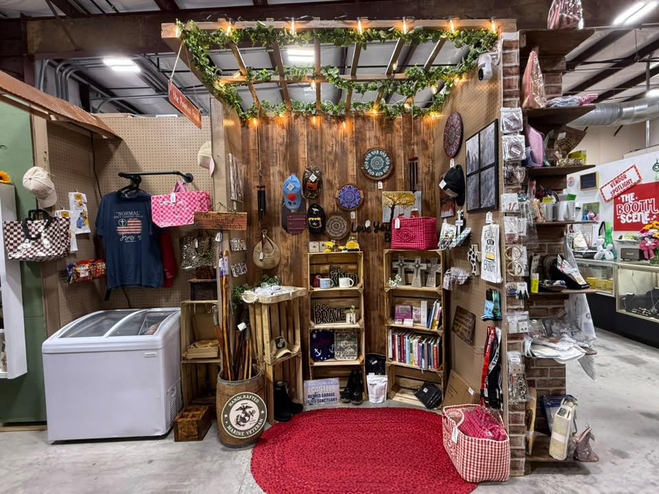 Rustic handmade booth with wood crates, signs, and hanging bags